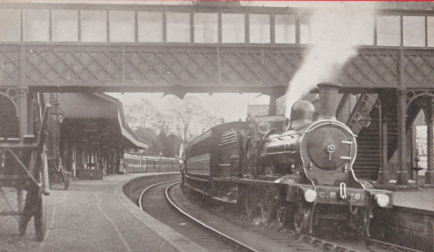 Callander station around 1900, showing its enclosed ornamental footbridge and platform railway scene