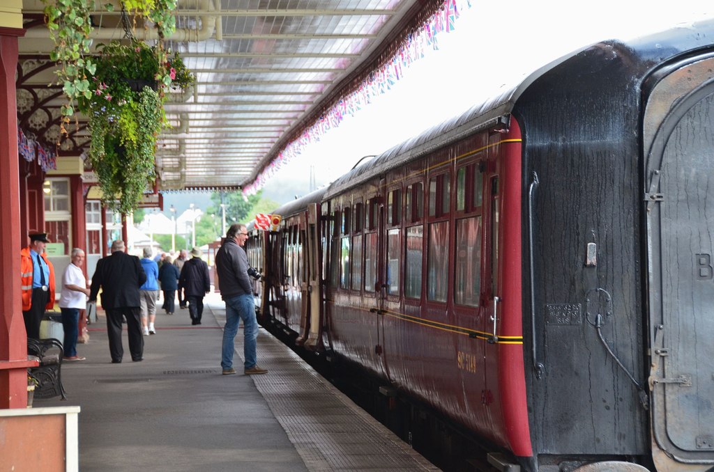 Maroon passenger carriages beside the platform at Aviemore on the Strathspey Railway