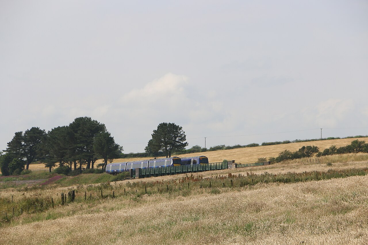 Two ScotRail trains crossing on Buckie Den Viaduct in the Angus countryside